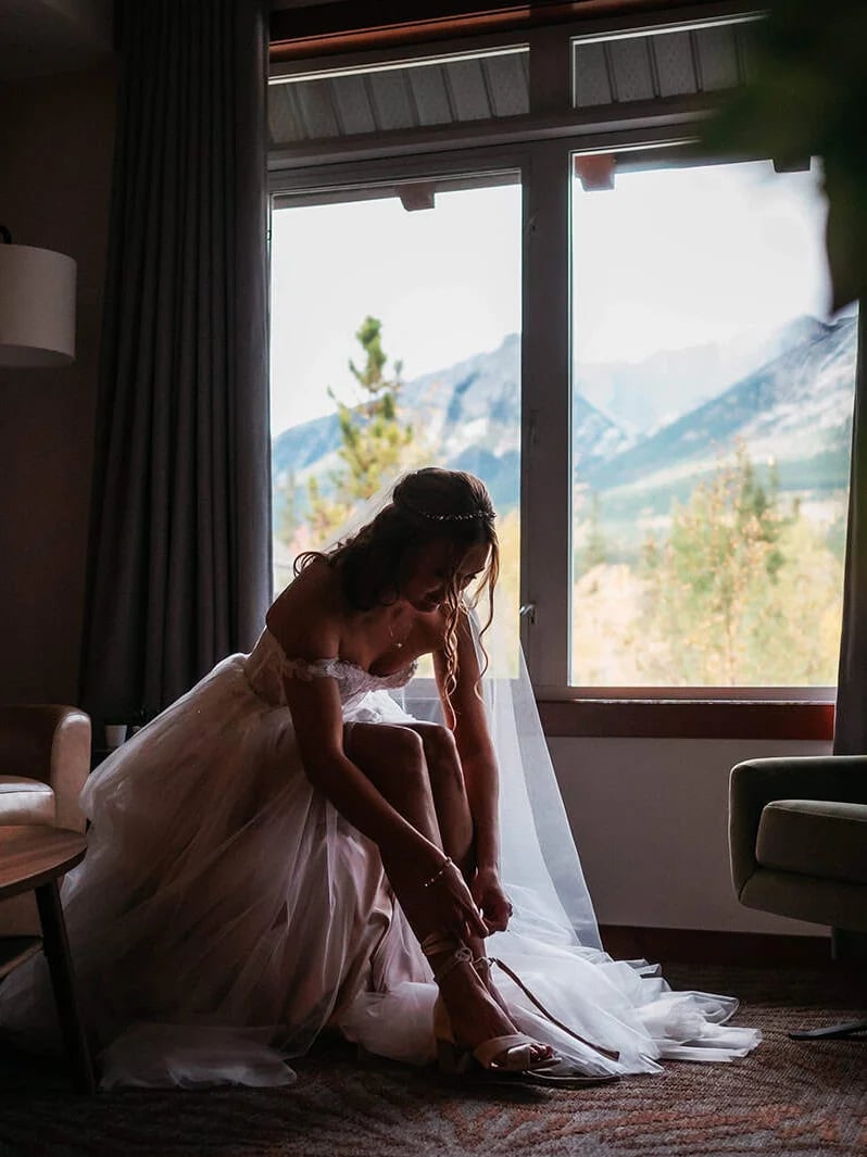 Bride fastening her shoe before the ceremony