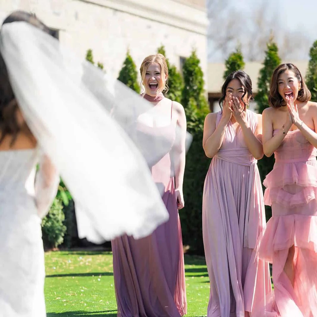 Bridesmaids celebrating together in natural light