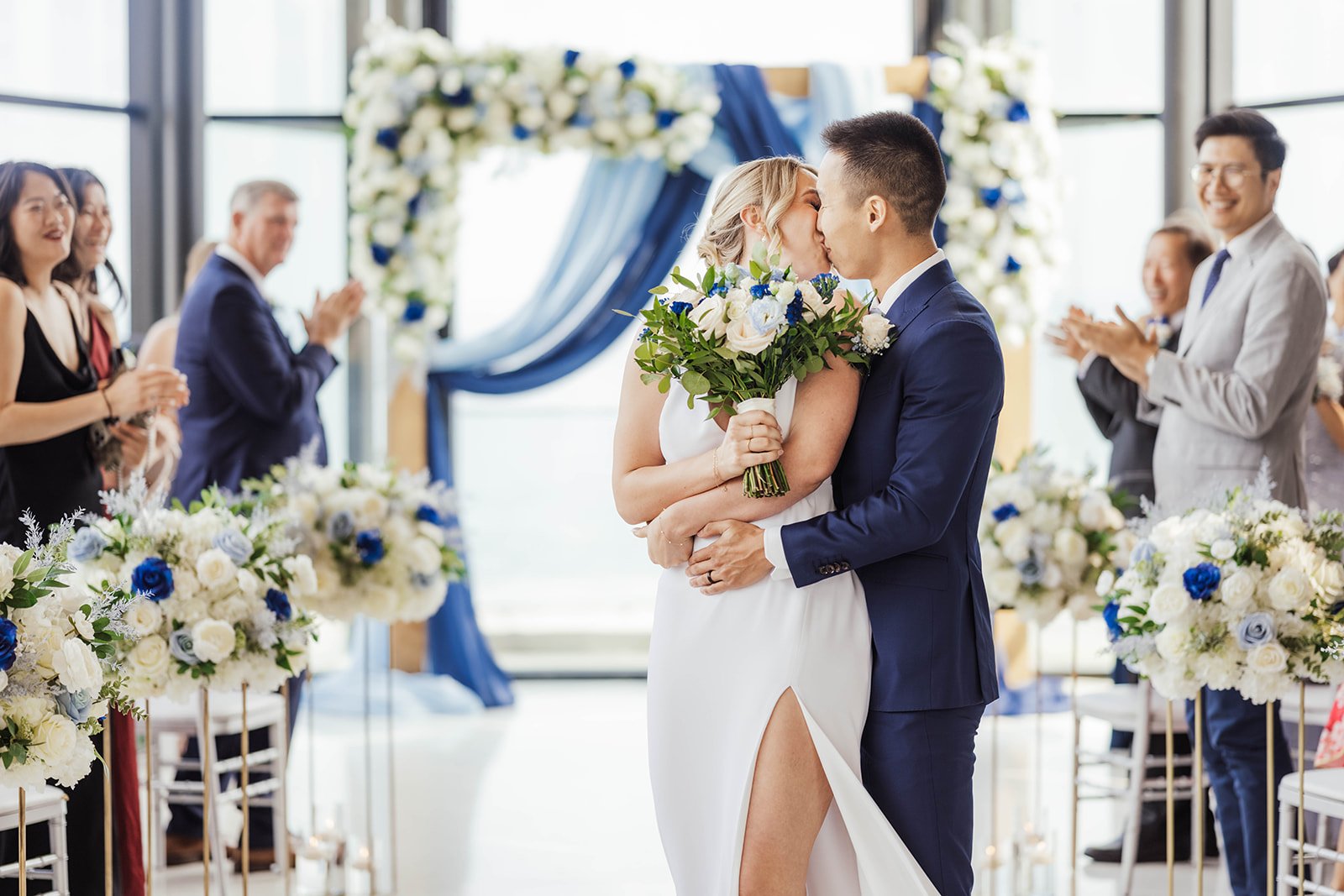 Bride and groom leaning together outdoors