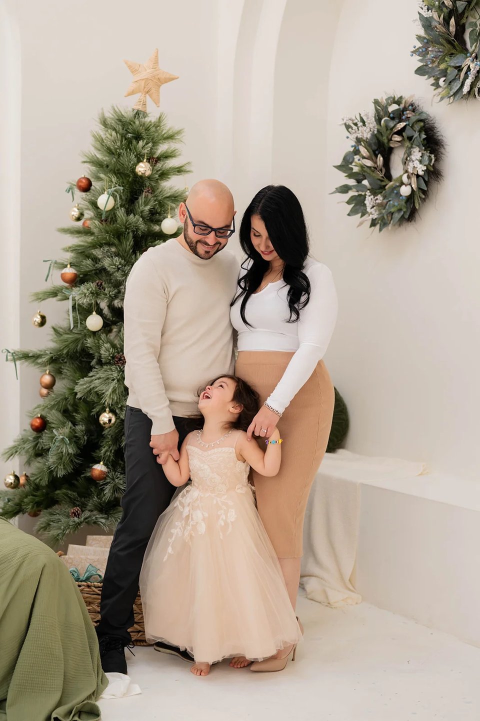 Family in front of Christmas tree